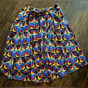 Brand new w/ tags. Elastic waistband. Comes past knees. Pockets on side.